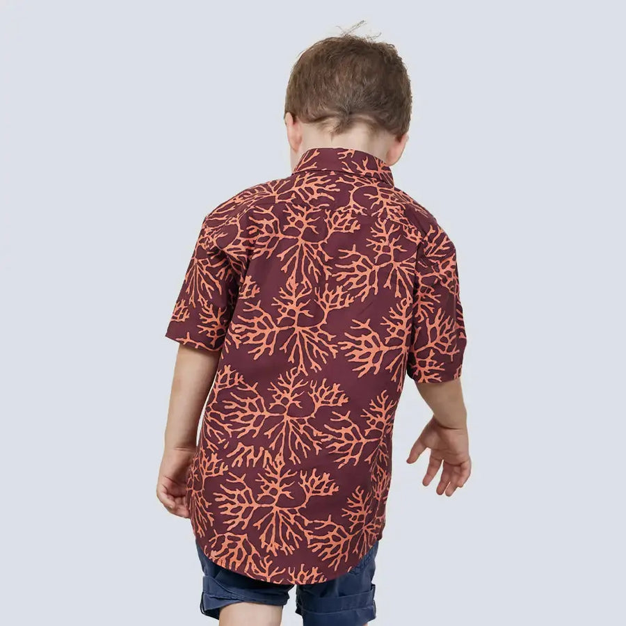 A young male model striking a pose with his back to the camera against a neutral backdrop, showcasing the Maroon Coral pattern