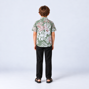 Boy facing back wearing green printed batik shirt