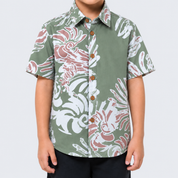 Closeup of boy wearing green printed batik shirt