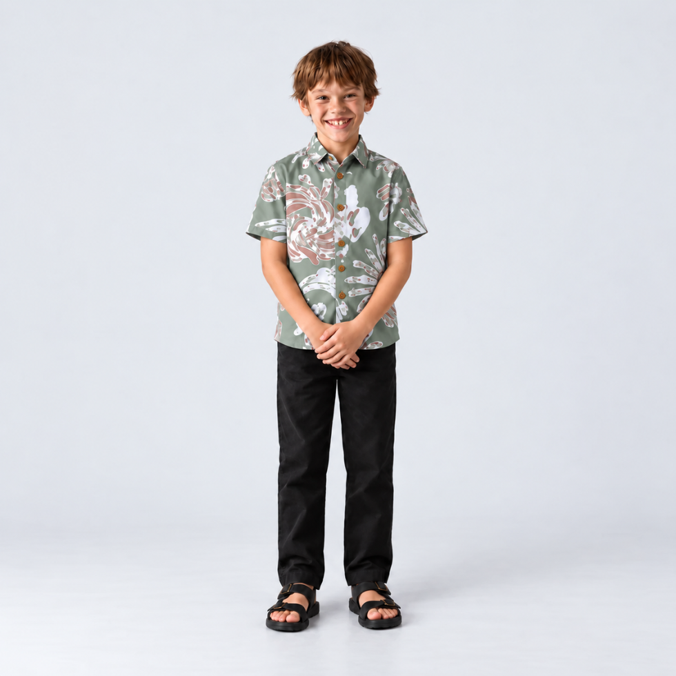 Boy facing front showing green printed batik shirt
