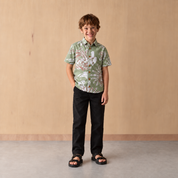 Kid wearing green shirt with wooden background