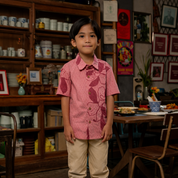 Child wearing a pink floral shirt standing in a room with wooden furniture and decor.