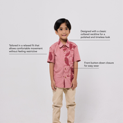 Child wearing a pink patterned shirt with text describing its features on a white background