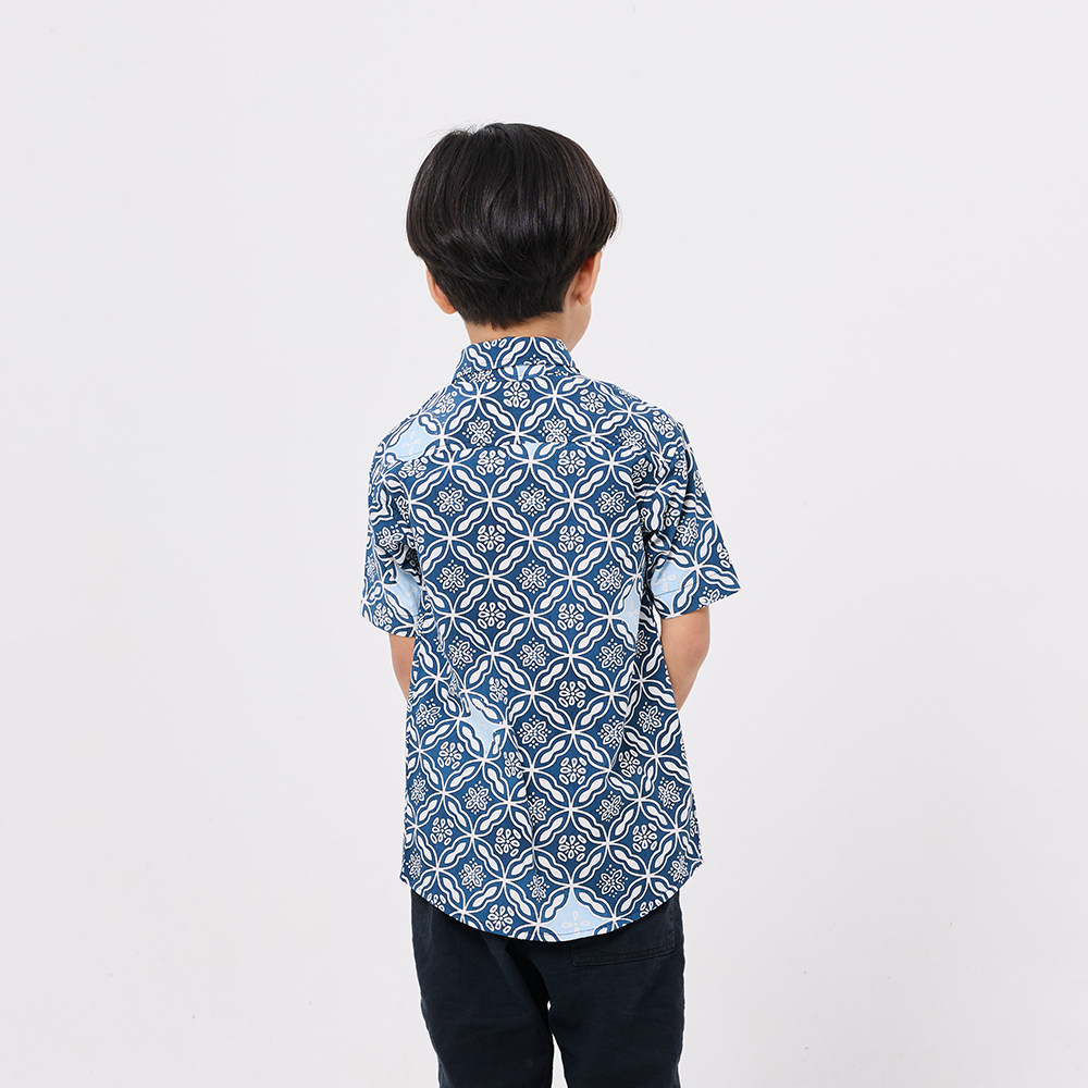 Person wearing a blue patterned shirt on a white background