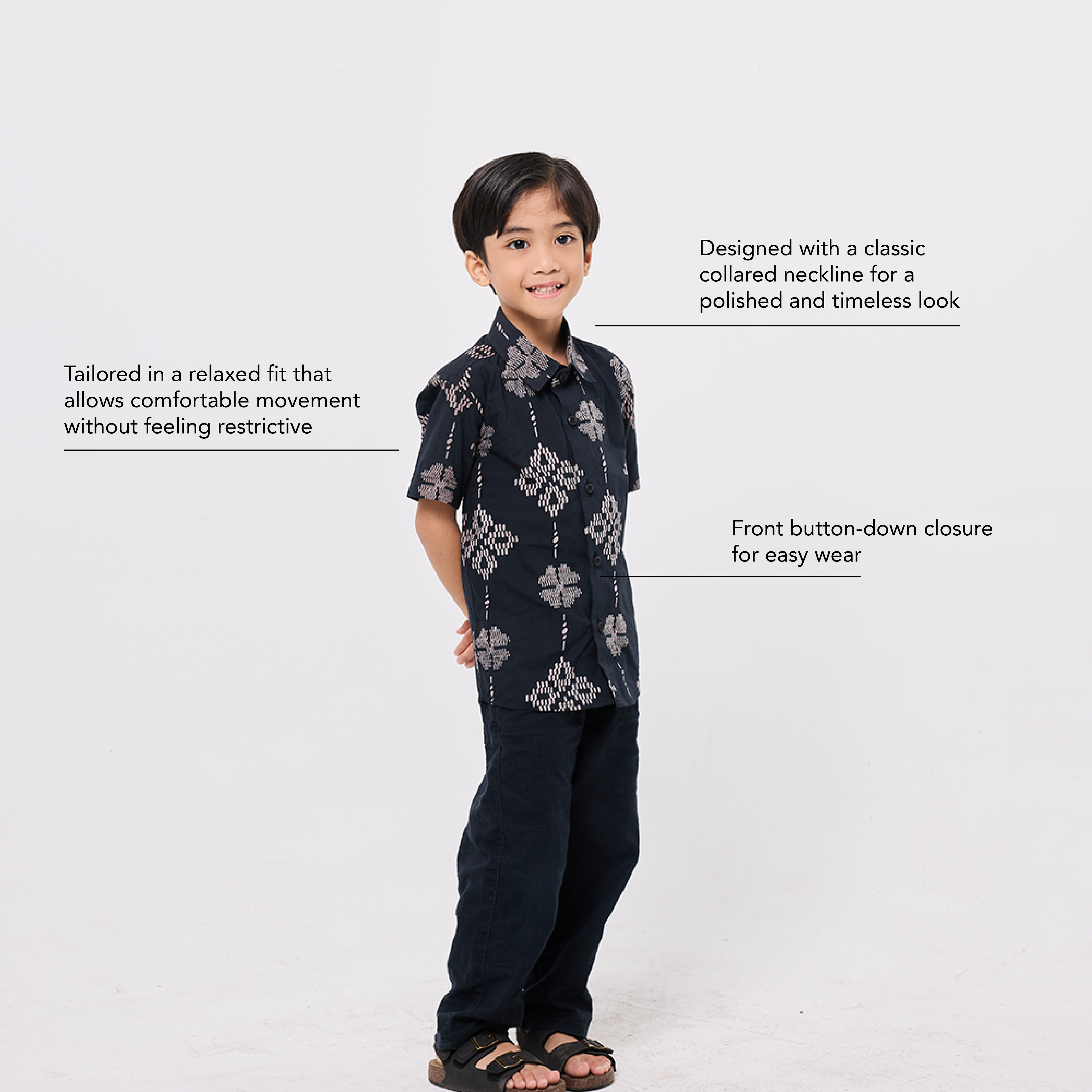 Child wearing a dark patterned shirt and pants on a white background with text about the clothing.