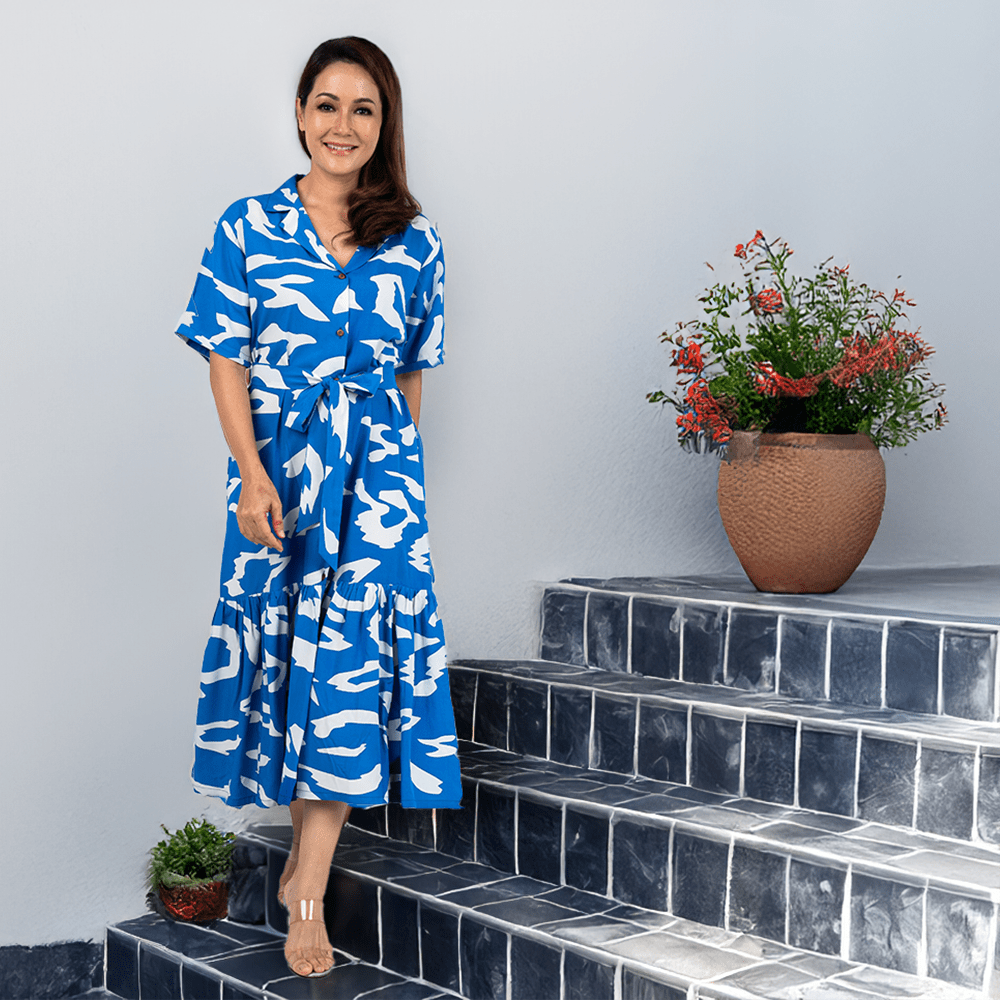 Woman wearing the blue rimba lifestyle photo button up dress 