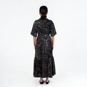 Back view of Batik Boutique’s Onyx Palma Button-Up Dress highlighting the batik motif and flowy A-line cut