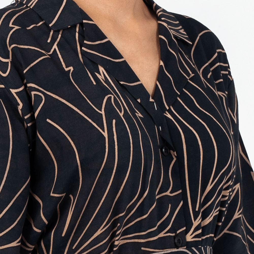 Close-up of Batik Boutique’s Onyx Palma Button-Up Dress showing fine batik-inspired linework and wooden button detailing