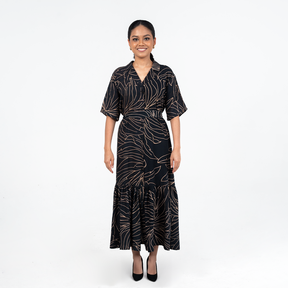 Front view of Batik Boutique’s Onyx Palma Button-Up Dress in black with soft gold botanical lines, styled with a flattering waist tie