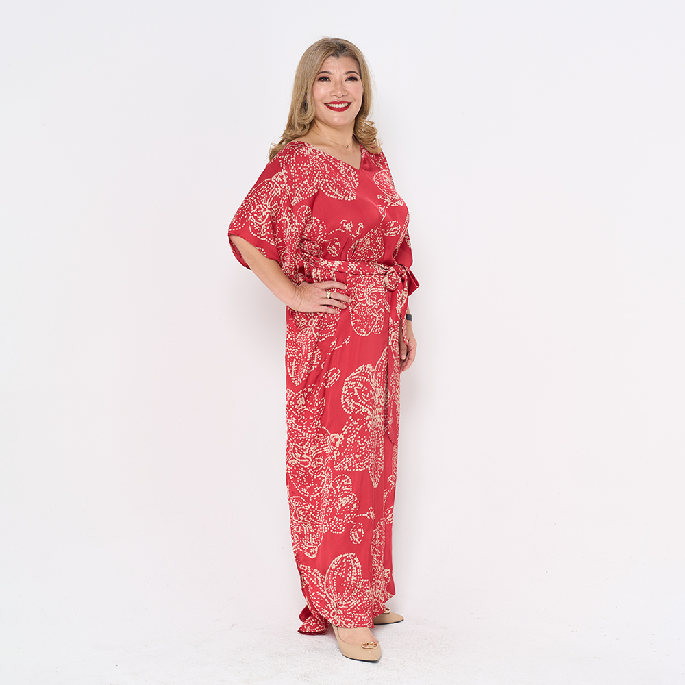 a woman posing in crimson orchid in batik caftan dress