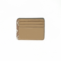 A whitebox photo of card case in genuine beige leather with a touch of batik fabric at the side in latte kompas pattern