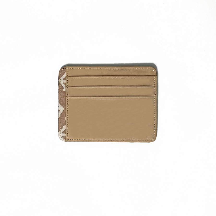 A whitebox photo of card case in genuine beige leather with a touch of batik fabric at the side in latte kompas pattern