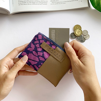 a photo of a card holder wallet in the pattern purple bintik with batik detailing 
