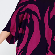 a closeup shot of batik kimono in the pattern fuchsia rose against a white background