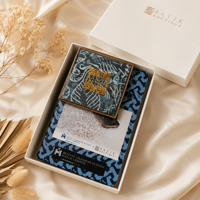 Boxed batik product with decorative elements on a soft beige background