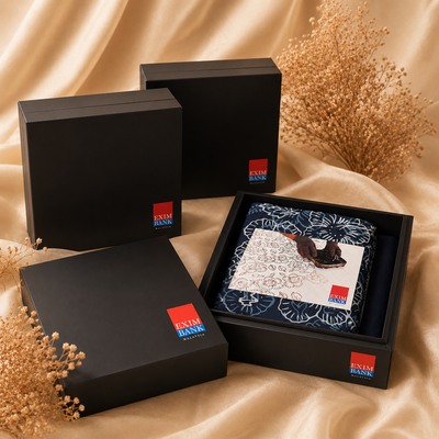 Set of black boxes with Evian Bank logo on a beige fabric background