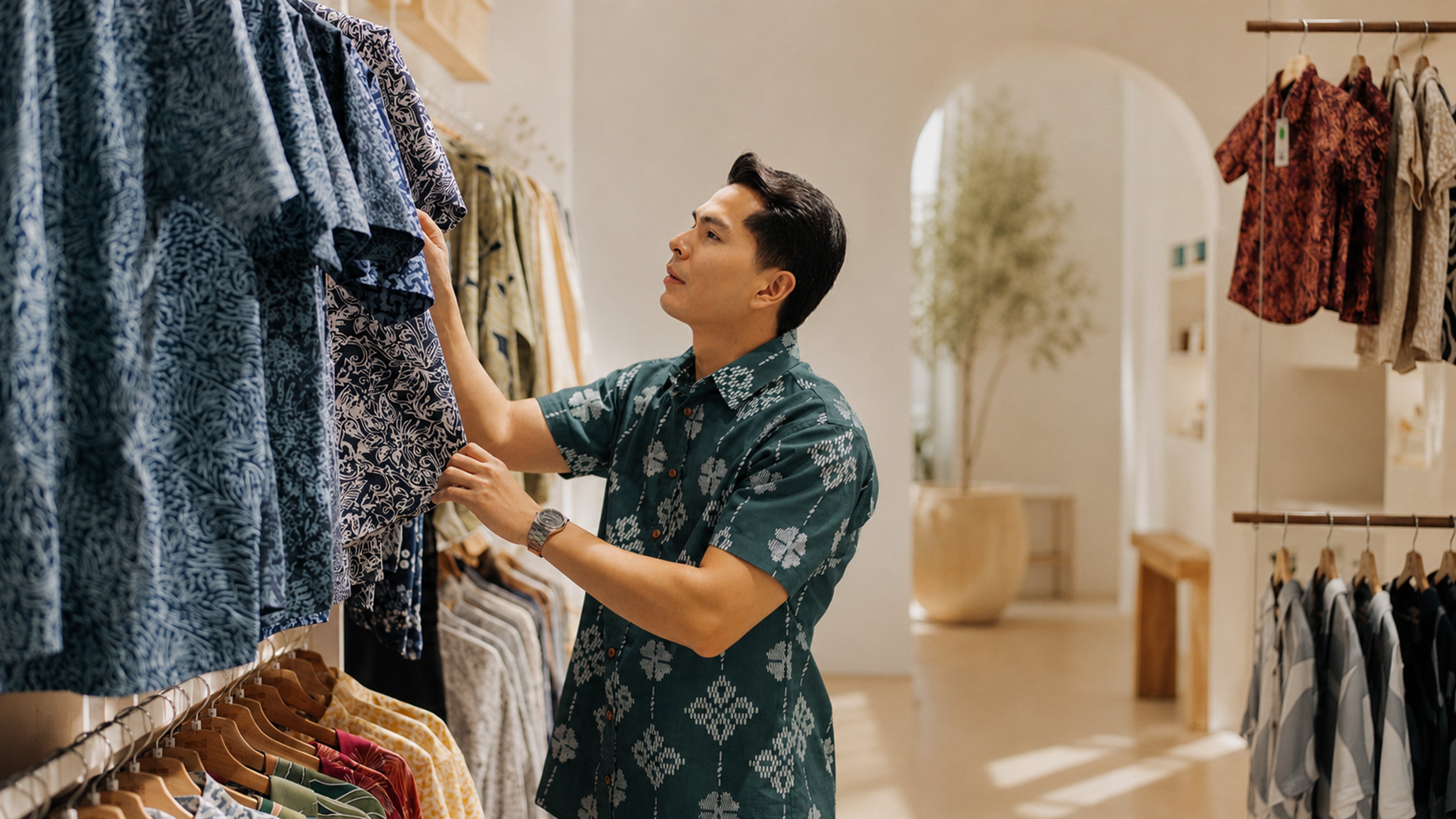 Man browsing through clothing in a store