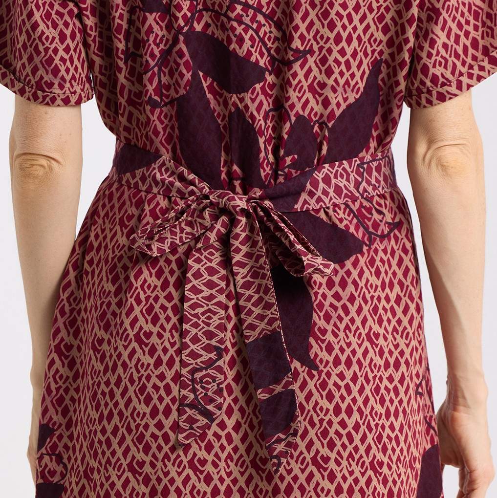 close up detailed shot the back of the button up copper blooming lace dress 