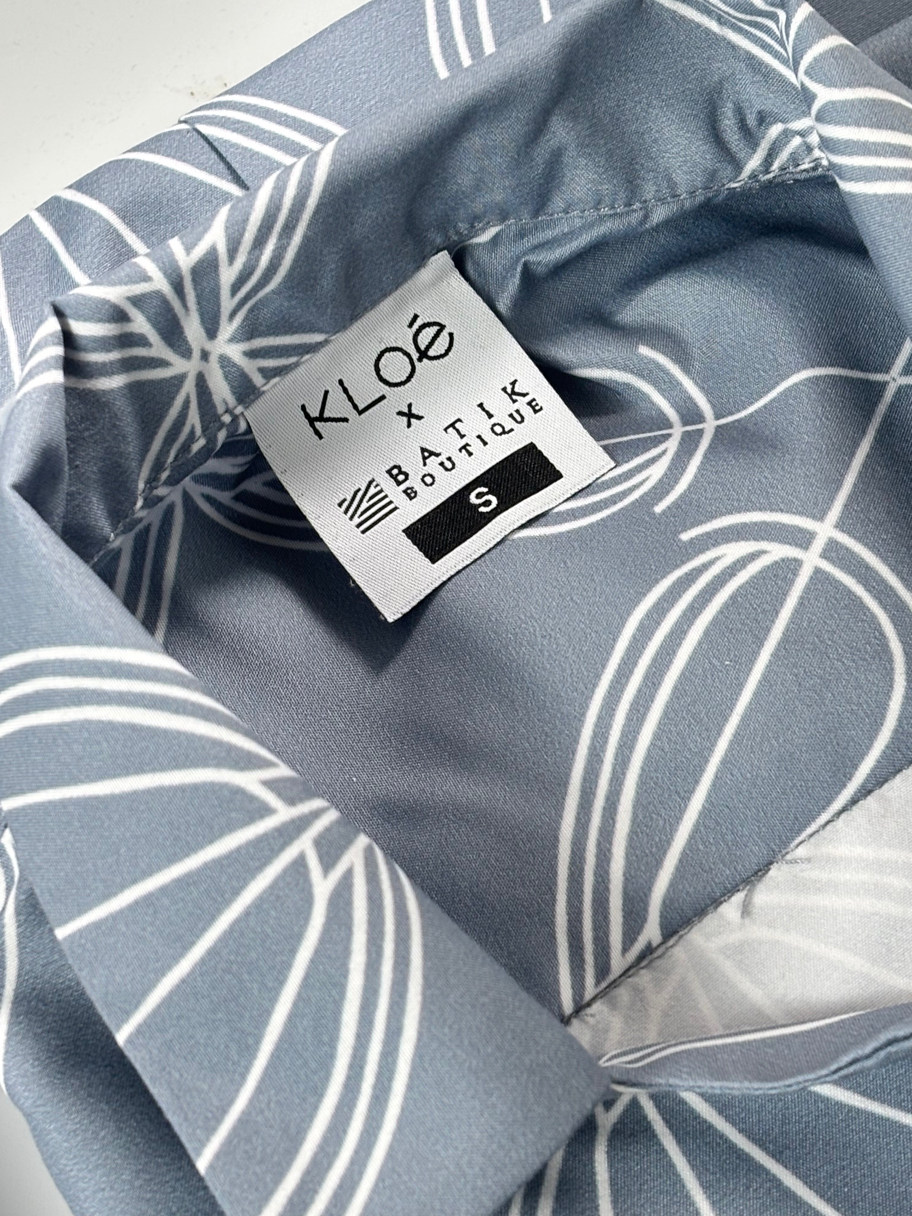 Close-up of a gray fabric with white line patterns and a KLOÓ label.