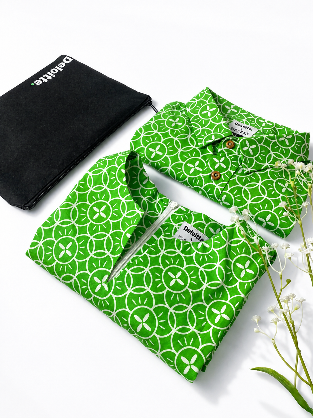 Green patterned shirt with matching pants and a black pouch on a white background