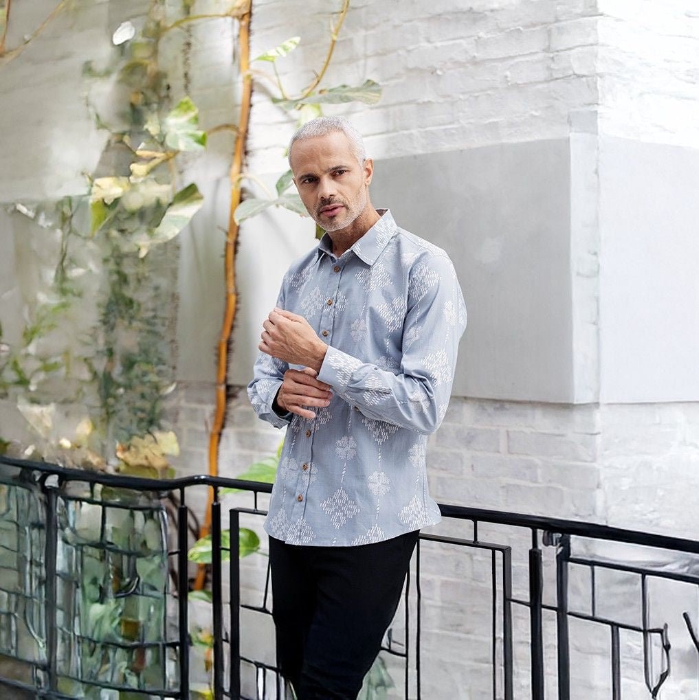 model wearing Diamond songket long sleeve shirt on a balcony 