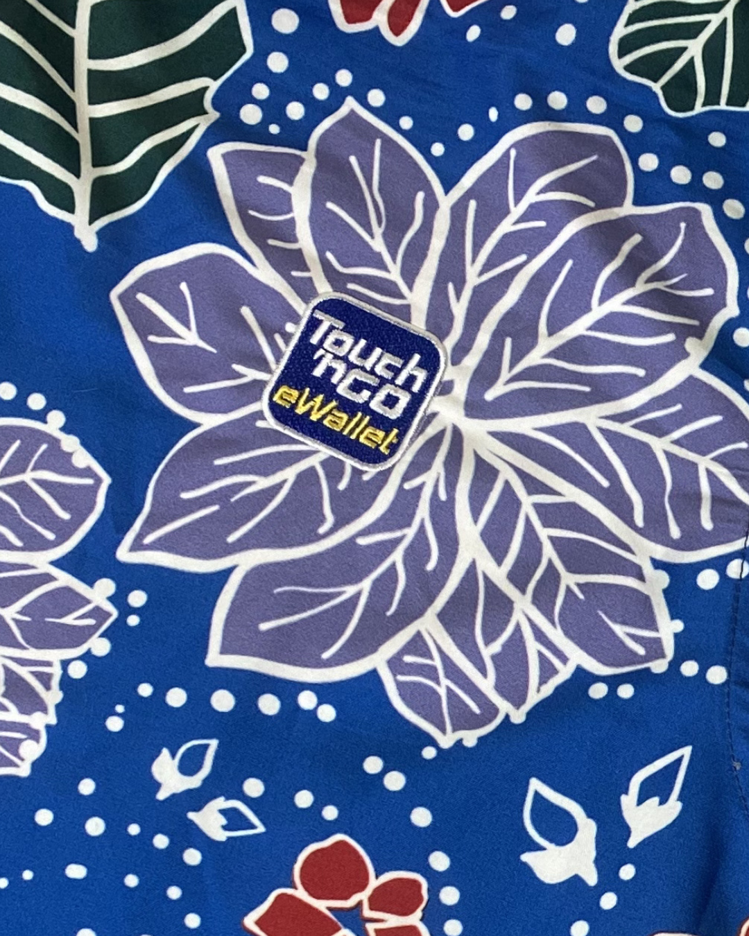 Floral patterned fabric with a 'Touch ID eWallet' logo.