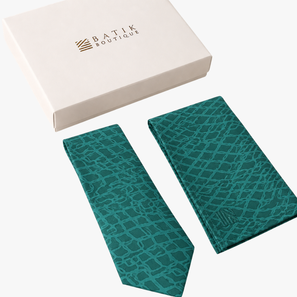 A teal and green batik tie set with a matching pocket square and a white gift box from Batik Boutique, displayed on a clean white background.