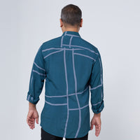 Back view of a man wearing and showcasing the long-sleeved batik shirt in Forest Green