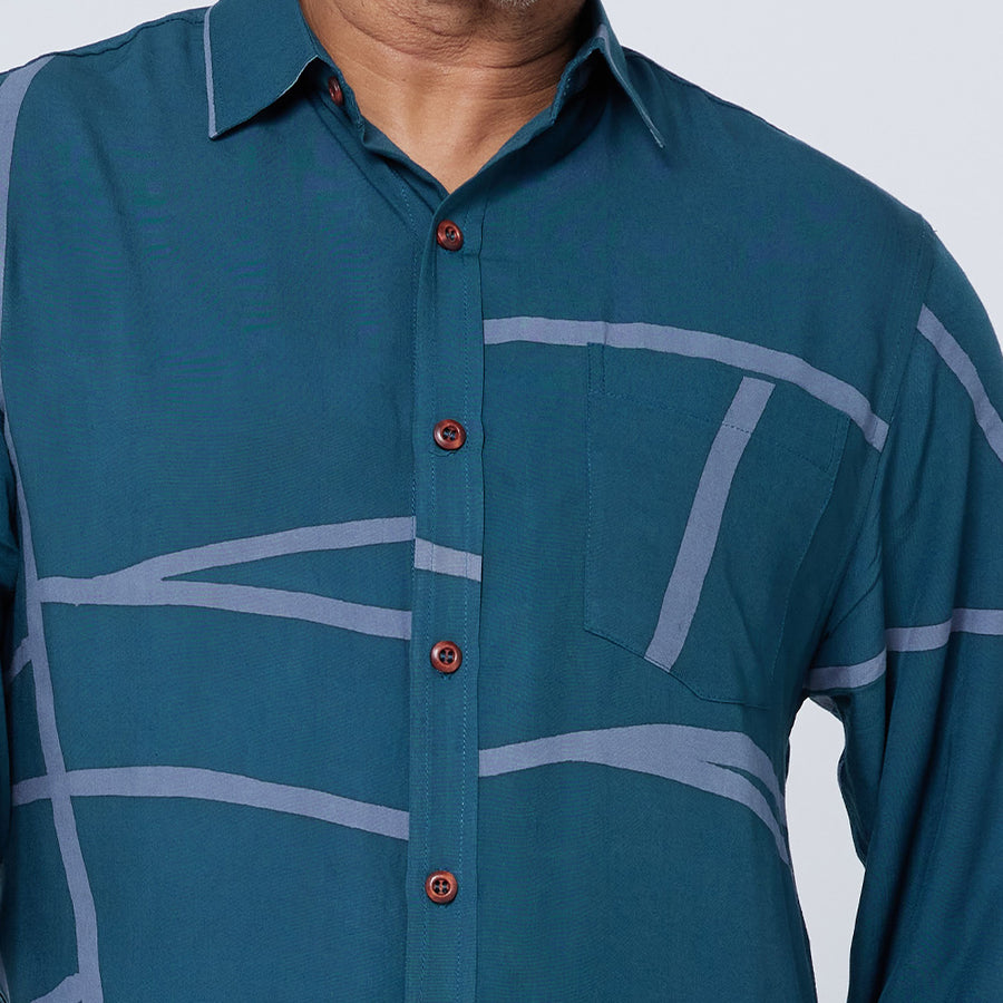 A close-up of a man's long-sleeved batik shirt in Forest Green 
