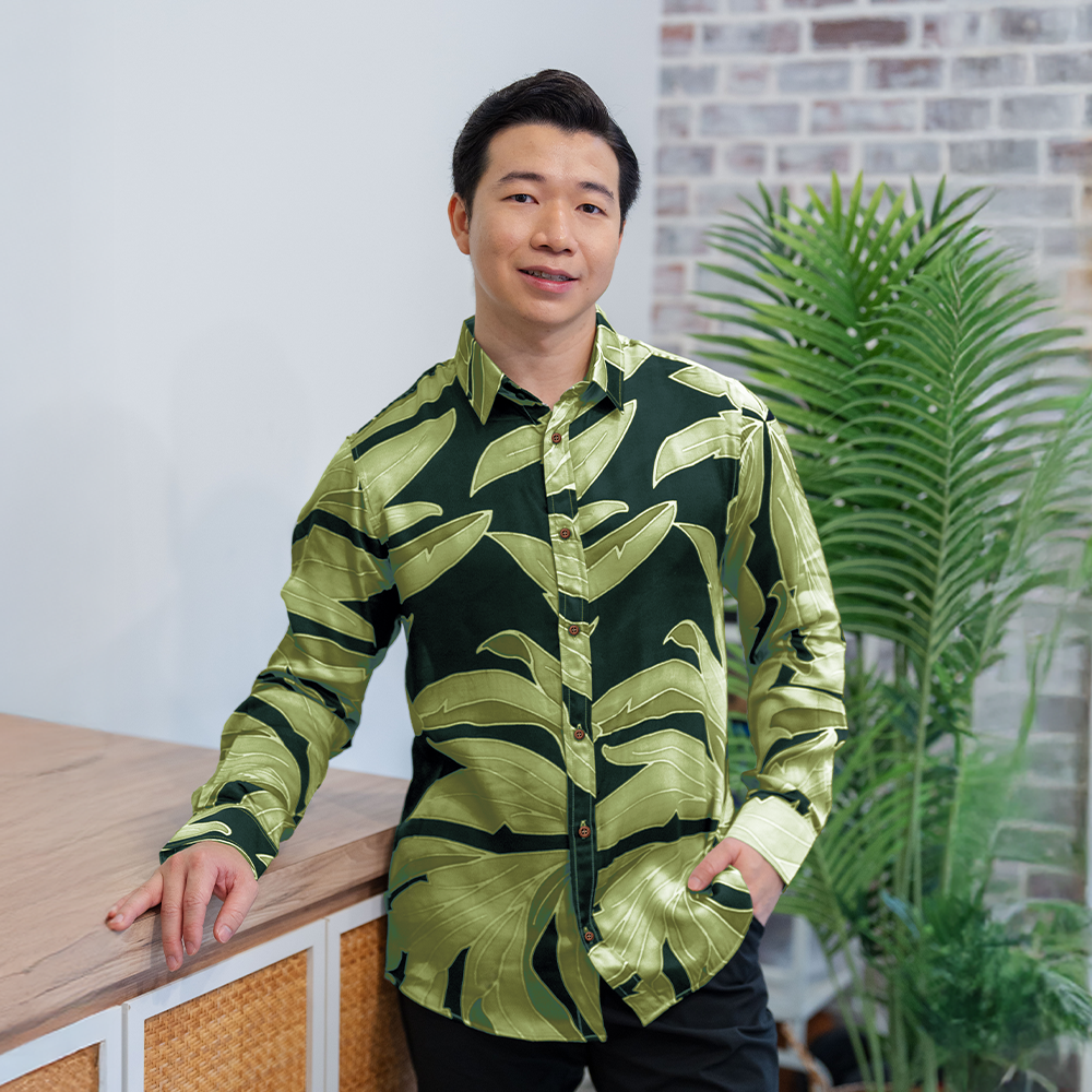 Man wearing Forest Palma long-sleeved batik shirt in green silk cotton