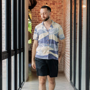 man wearing a lavender bukit cuban shirt in a lifestyle photo 