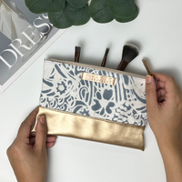 a picture of a batik batik pouch in the pattern grey peony against a neutral background