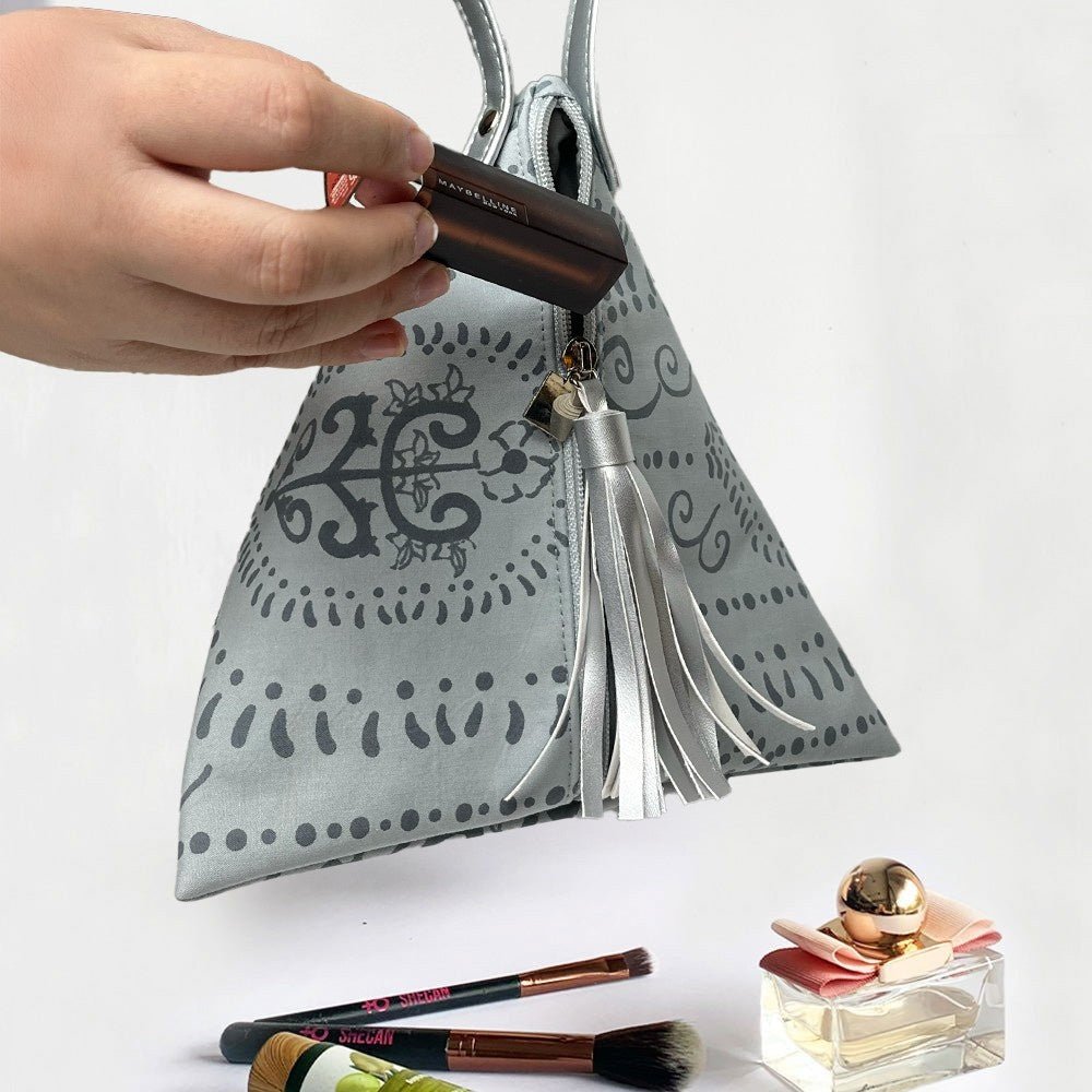 Ketupat Bag in grey Petola  shown being used to store makeup