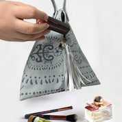 Ketupat Bag in grey Petola  shown being used to store makeup