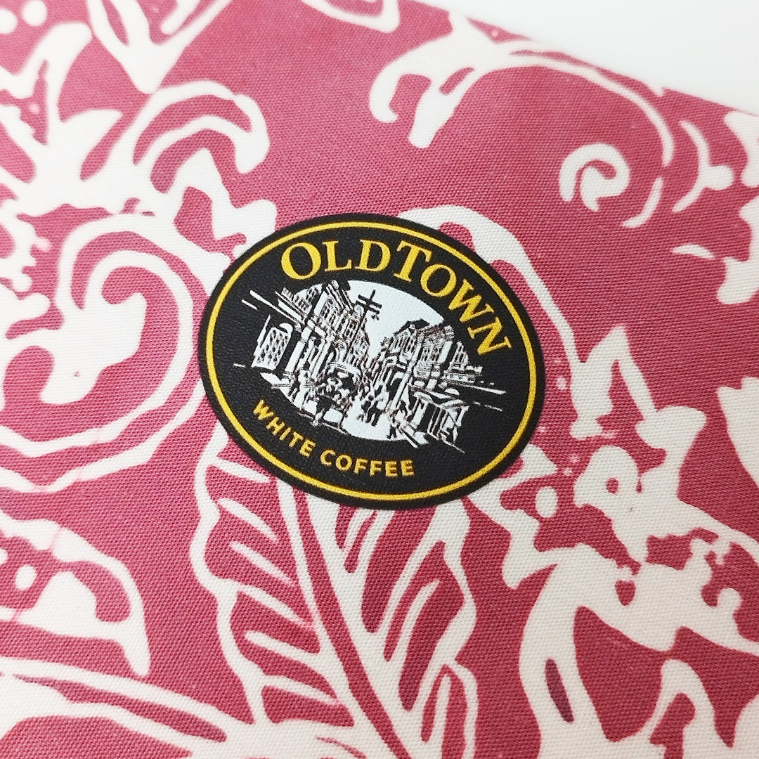 Old Town White Coffee logo on a pink and white patterned fabric