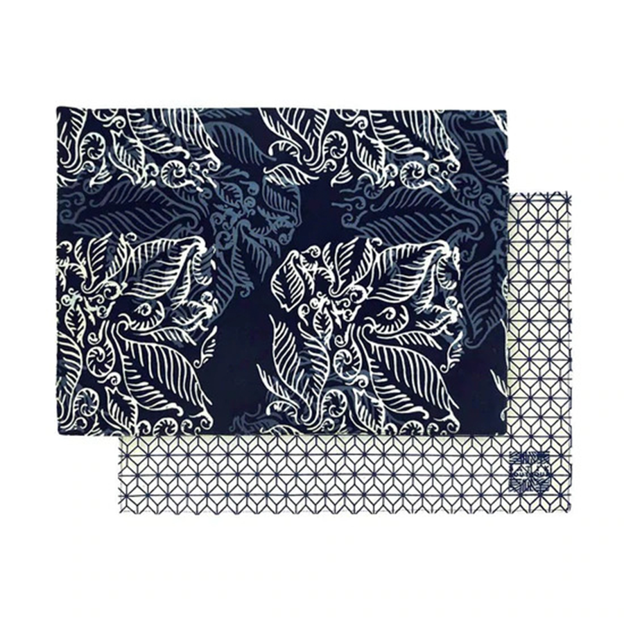 two batik placemats in the pattern blue nautical fern that's also reversible against a neutral background