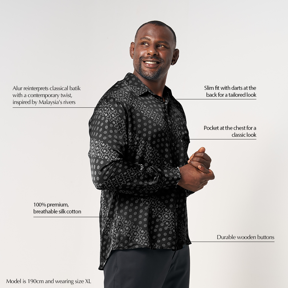 Product detail highlighting the unique selling points of the Black Alur batik shirt, including the contemporary twist on traditional batik, slim fit with darts at the back, durable wooden buttons, and breathable silk cotton fabric.