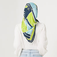 A hijabi model wearing batik scarves in teal rimba print