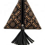 A black and tan patterned zippered clutch bag with a black tassel, shown against a plain white background.