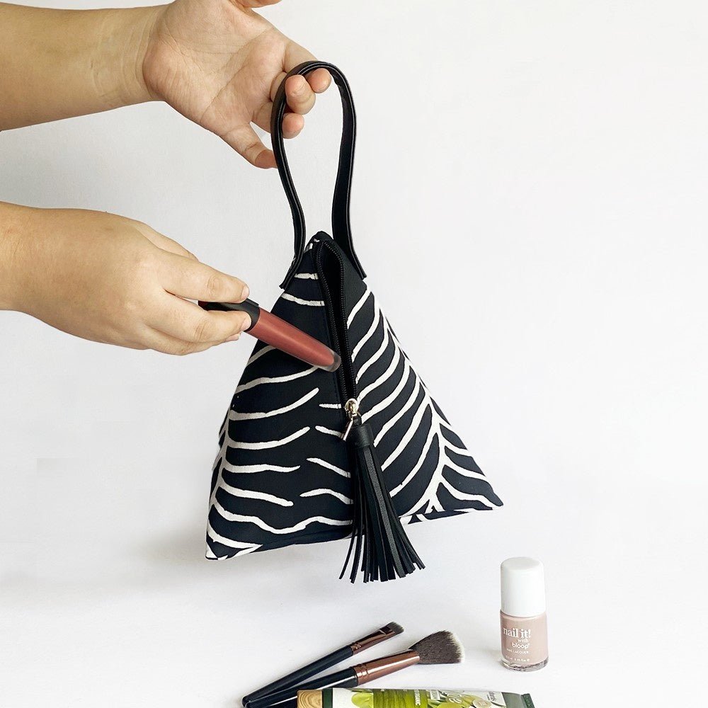 Ketupat Bag Black Fern being shown with makeup 