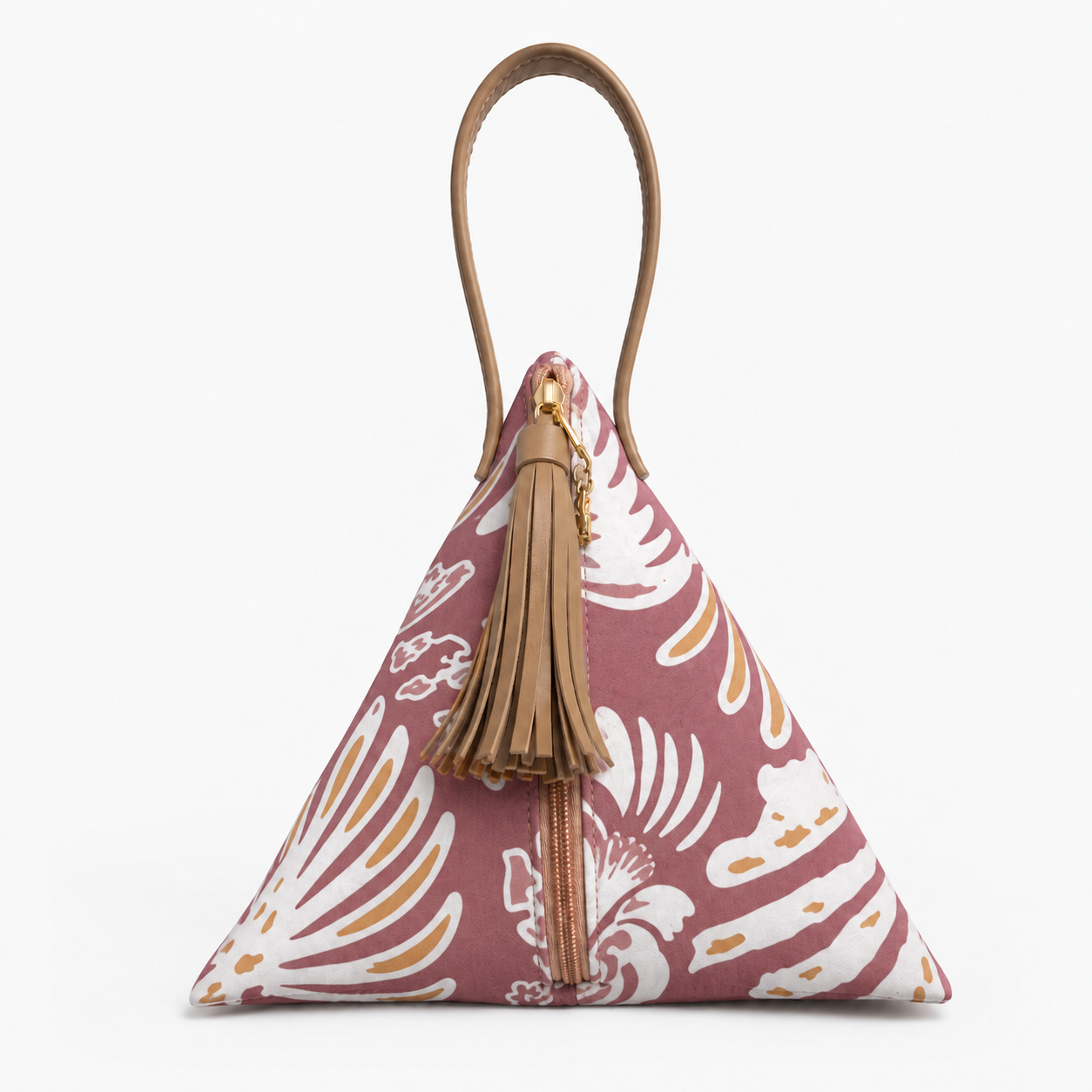 A small pyramid-shaped handbag with a maroon and tan floral pattern, featuring a tan leather top handle, a tan leather tassel charm, and a gold front zipper, shown against a plain white background.