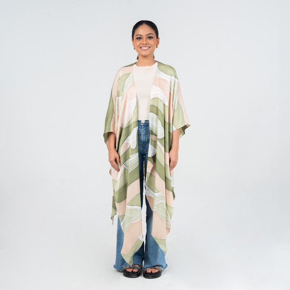Front view of model wearing Moss Bukit batik kimono by Batik Boutique, styled casually with jeans and a white top