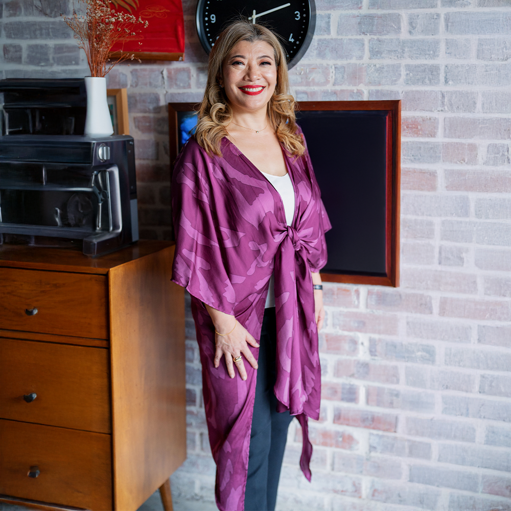 a woman posing in a batik kimono plum rimba in a lifestyle background