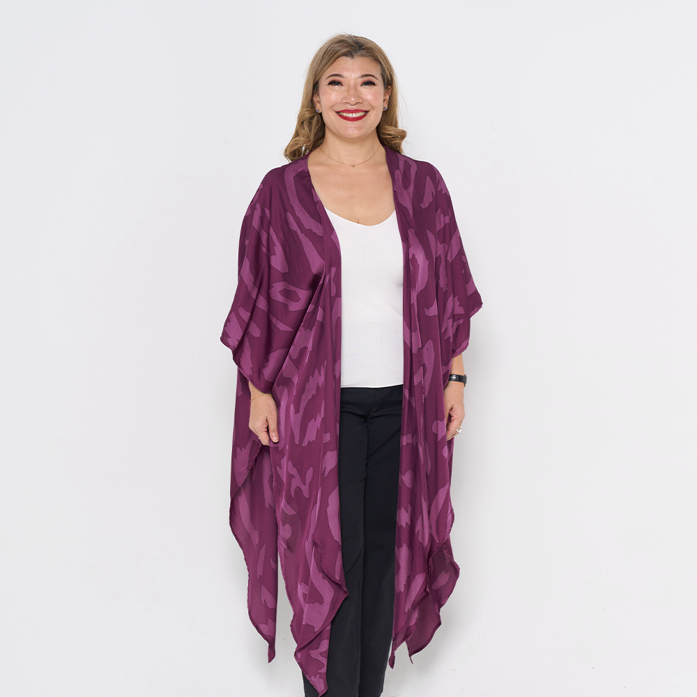 a woman posing in plum rimba against a white background