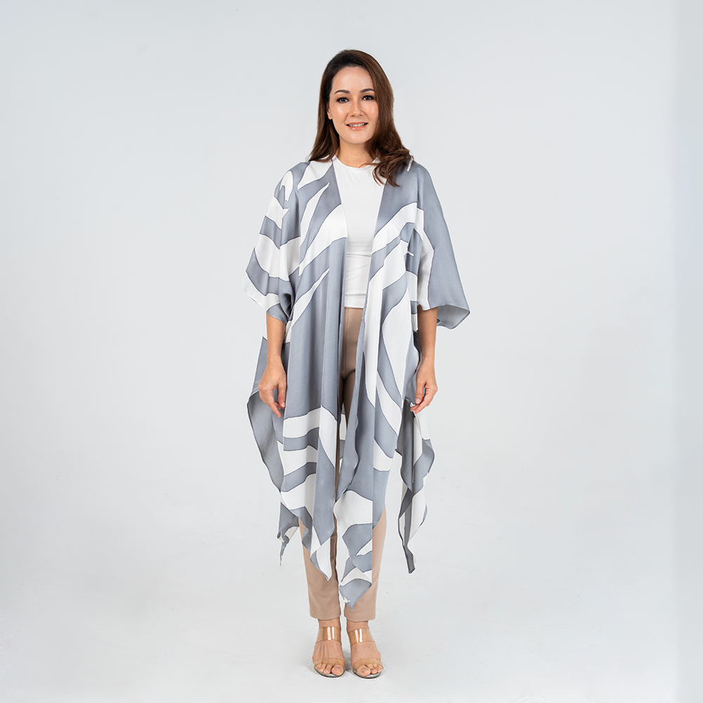 Model in front view wearing Batik Boutique’s Silver Rose batik kimono in soft silver and white tones, styled over neutral outfit