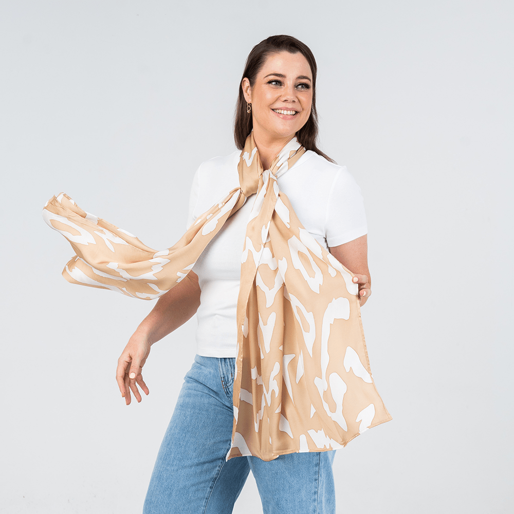 women wearing tan rimba scarf in a lifestyle photo 