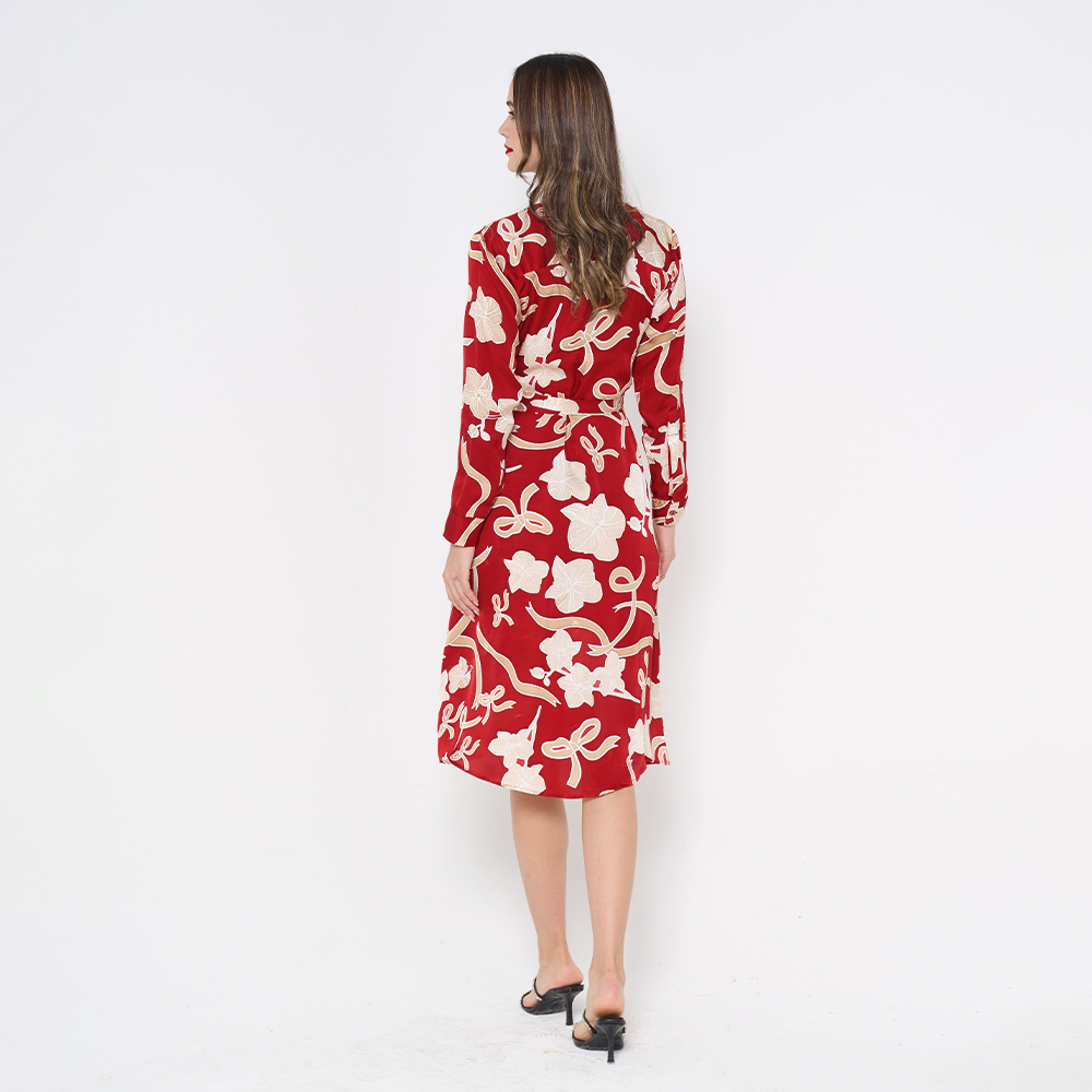 a woman showcasing the back of batik long shirt dress in the pattern ruby fleur