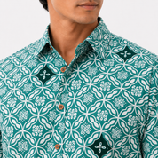 Man wearing a green patterned shirt with white floral design