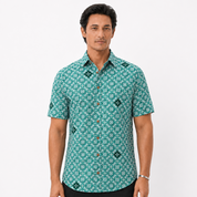 Man wearing a green patterned shirt on a white background