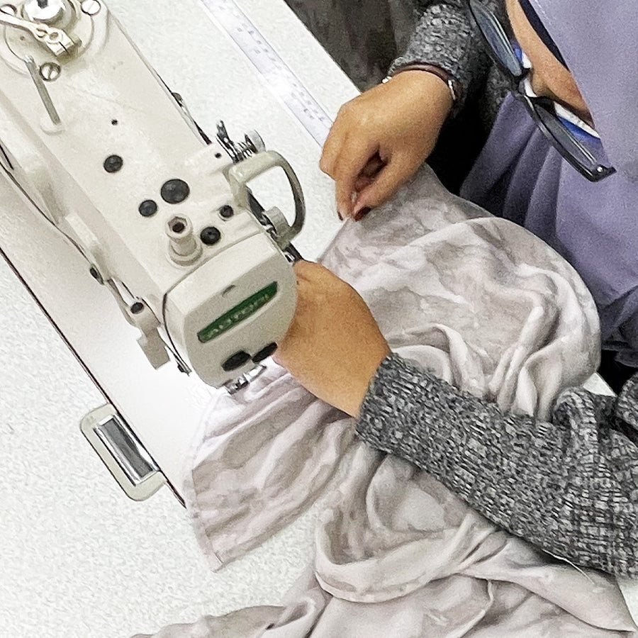 A seamstress is sewing shibori fabric in mangosteen pattern
